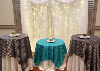 two round tables with black and white tablecloths