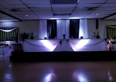 a stage set up for an event with purple lighting