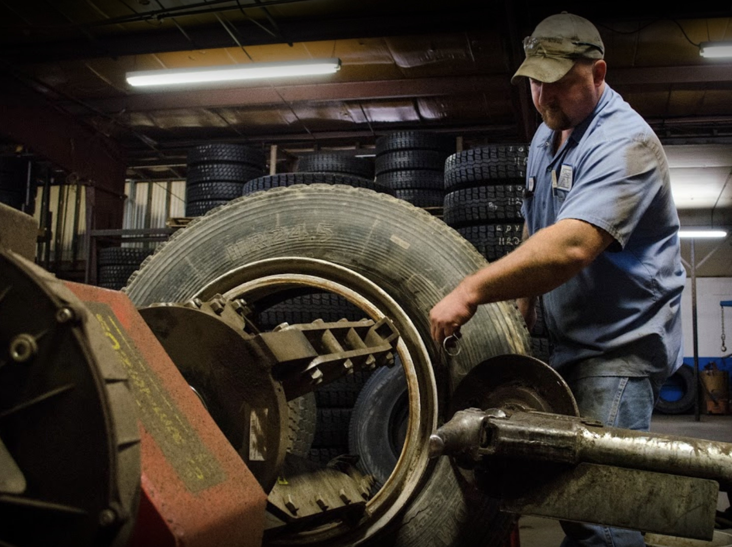 a man working on a tire in a garage