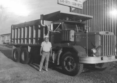 a man standing next to a large truck