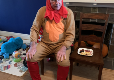 a man in a turkey costume sitting on a chair
