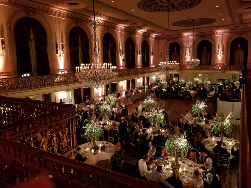 an overhead view of a banquet hall with tables and chandeliers