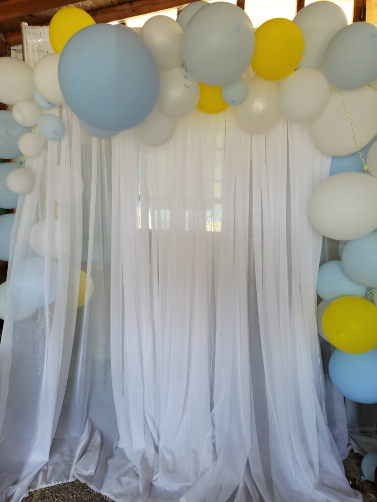 a bunch of balloons hanging from a ceiling