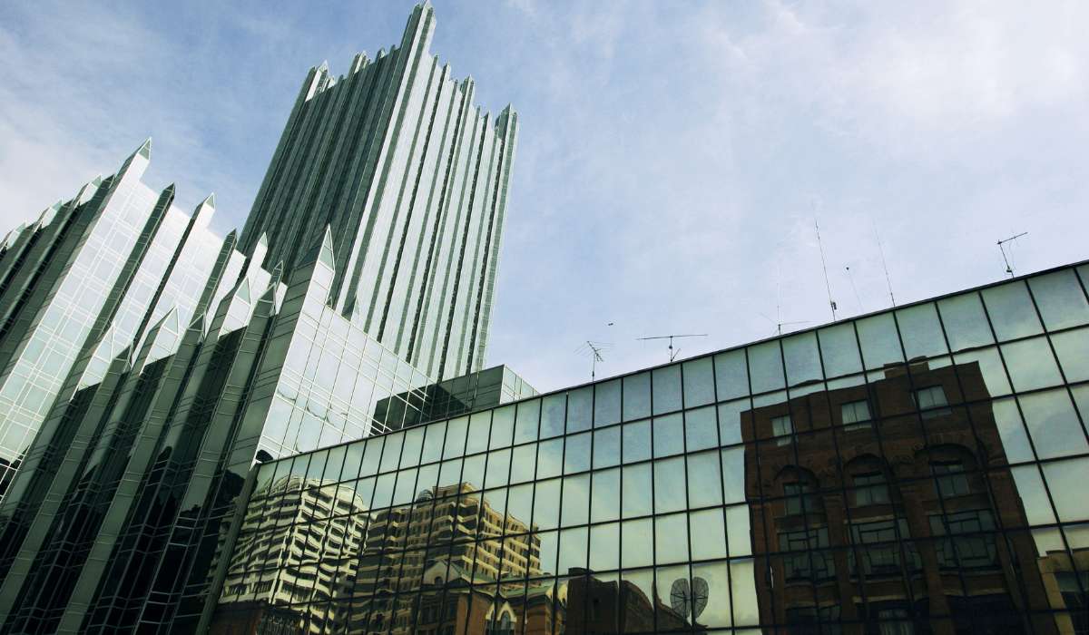 the reflection of buildings in the windows of another building
