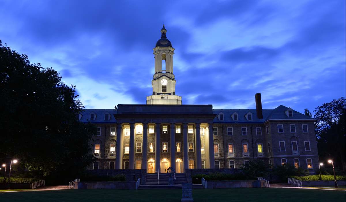 a large building with a clock tower lit up at night