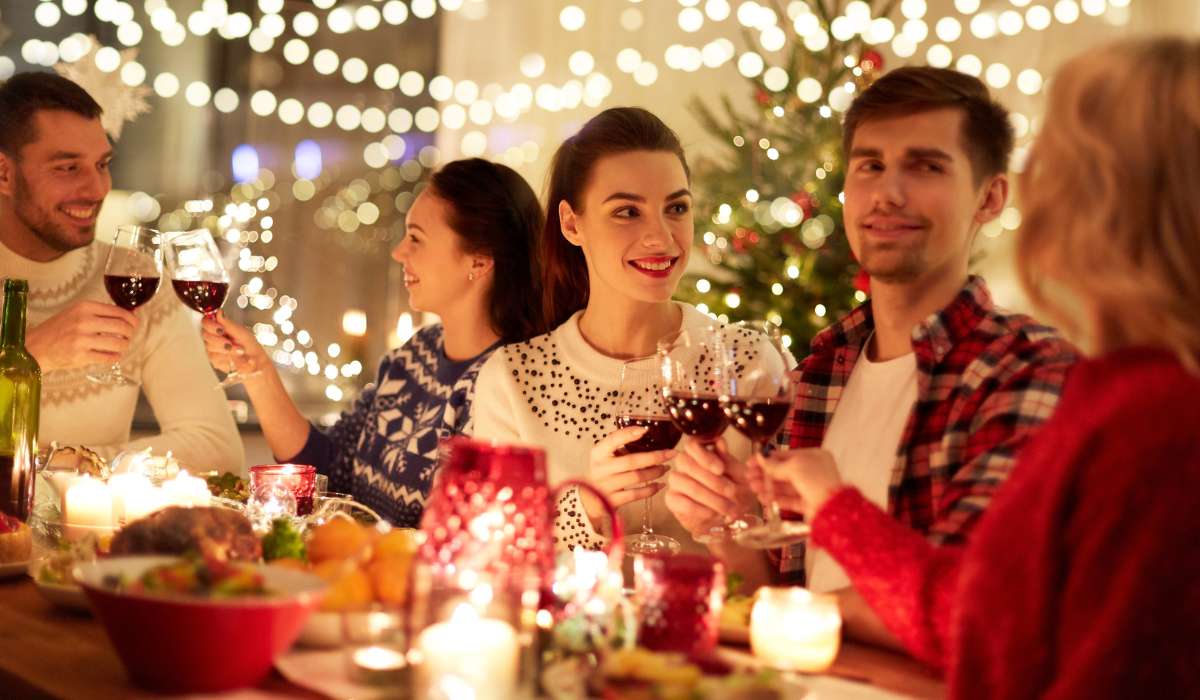a group of people sitting around a table with wine glasses