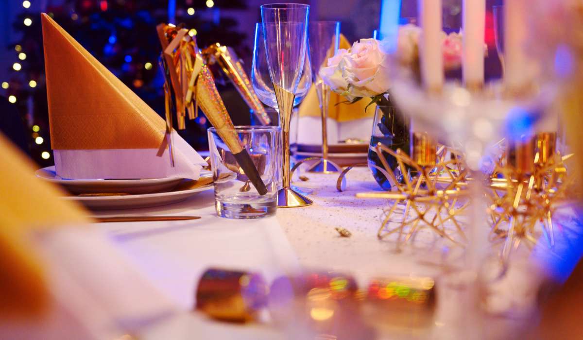 a table set for a party with candles, plates and napkins