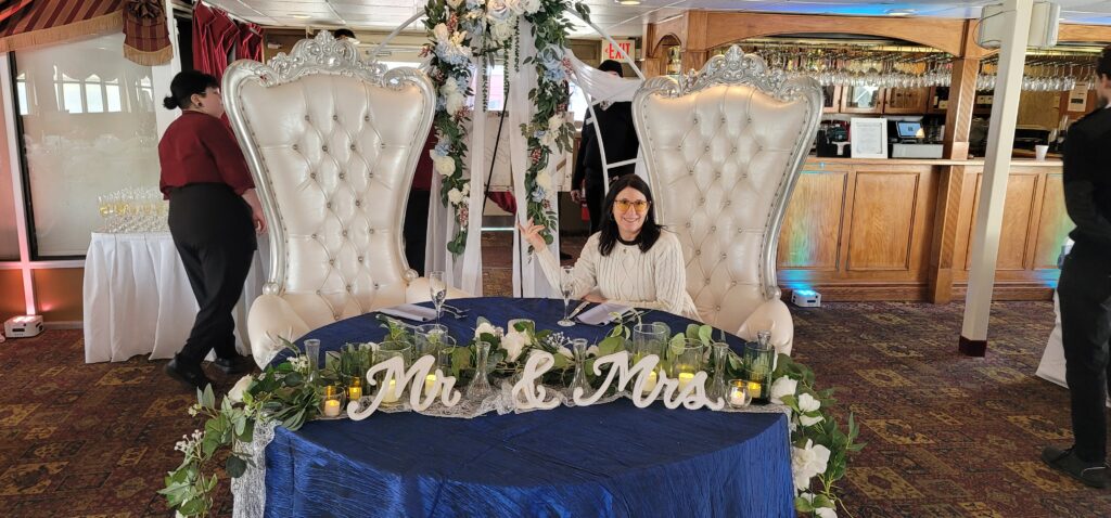 a woman sitting at a table with a blue table cloth